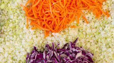 close up of diced coleslaw with carrots and red cabbage separated