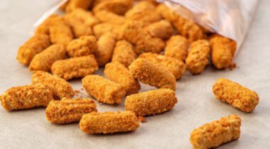 cheese sticks spread out on brown table from opened package