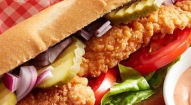 chicken sandwich with tomato, onions and pickles