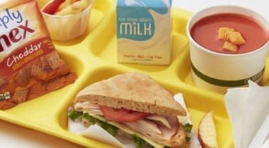turkey sandwich with tomato soup and chex mix on school tray
