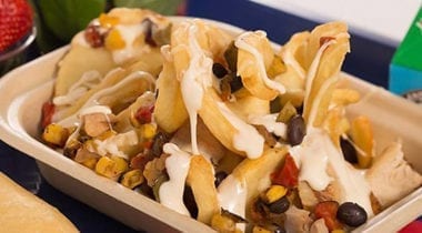 roasted nachos with strawberries and breadstick on school tray