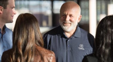 man smiling at group